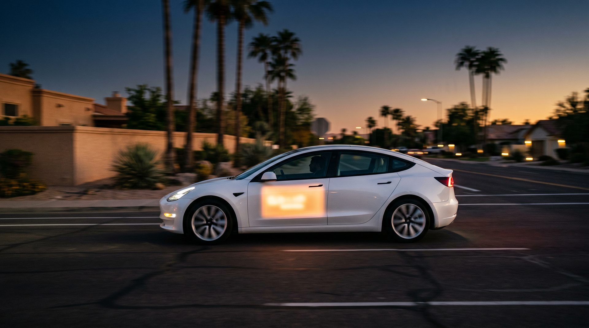 A vehicle with a glowing amber ad panel driving through Phoenix at golden hour